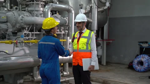 Group of Industry Engineer discussion with clipboard checking information and Stock Footage 154283223