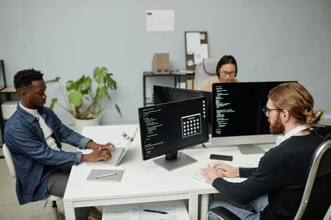 Group of intercultural software engineers working in front of computer monitors 写真素材