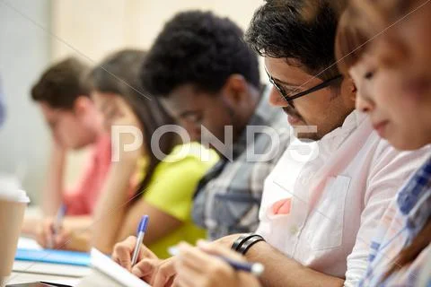 Group of international students writing at lecture Stock Photos