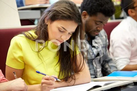 Group of international students writing at lecture Stock Photos