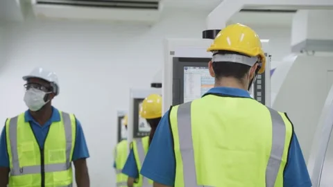 Group of interracial worker wearing face mask in production factory. Stock Footage 147910931