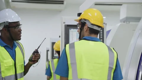 Group of interracial worker wearing safety equipment in factory. Stock Footage 147910907