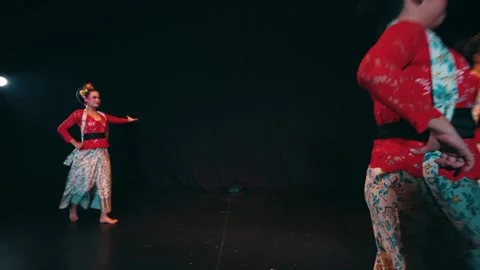 Group of Javanese Dancers Moving Across Dark Stage Stock Footage 263949448