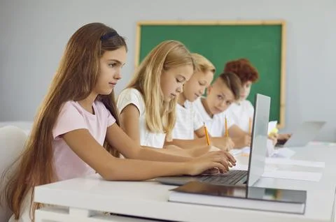 Group of junior high school students are studying using laptop in computer Stock Photos