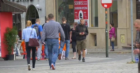 Group of Kids Appears from behind the Corner of Building Kids in Orange Stock Footage 54839180