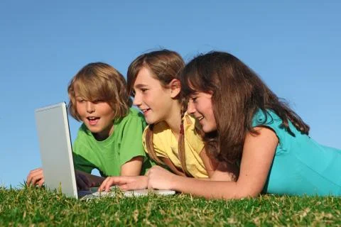 Group of kids with computer on internet Stock Photos