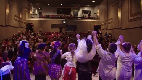 Group of kids at the end of a performance in front of cheering crowd Stock Footage 85286355