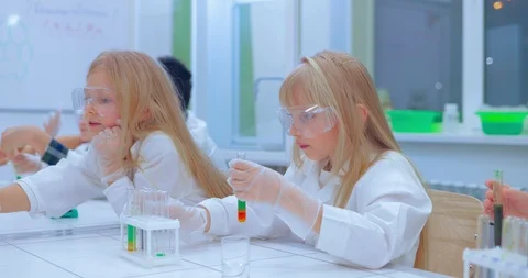 Group of kids making experiments in chemistry class. Children in chemistry class Stock Footage 85798652