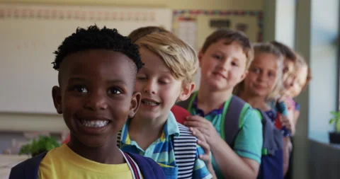 Group of kids standing in a queue in school Stock Footage 135453674