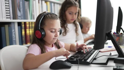 Group of kids students using computer sitting on table at classroom Stock Footage 230938906