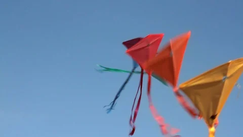Group of kites tied together while floating against a blue sky. 스톡 동영상 88341826