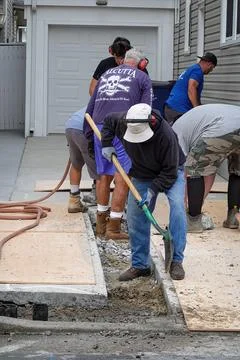 Group of laborers are see digging a trench for a new water line after break.. Stock Photos