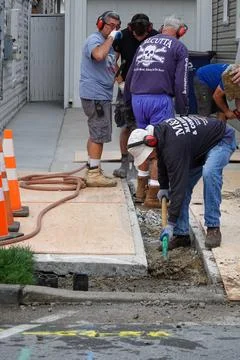 Group of laborers are see digging a trench for a new water line after break.. Stock Photos