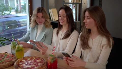 Group of ladies using mobile phones in cafe Stock Footage 259837541