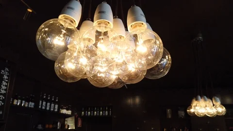 Group of large, warm colored light bulbs shot in cafeteria Stock Footage 111081050