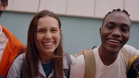 Group laughing young multiracial students hugging in human chain. University Video stock 247155099
