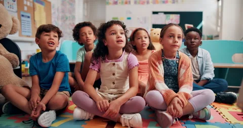 Group, learning and students listening to storytelling in classroom of school Stock Footage 303713858