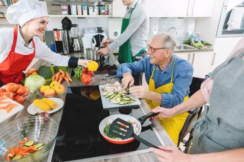 Group learning cooking in training kitchen with nutritionist Foto stock