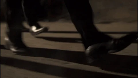 Group of legs/shoes walking down a dark alley Stock Footage 85572769