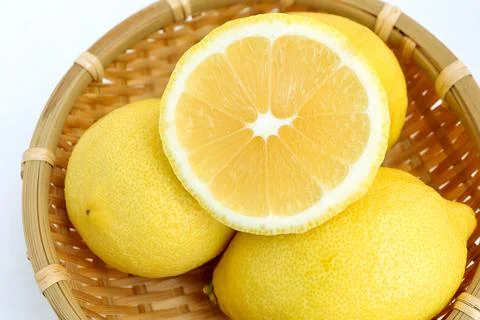 Group of lemons in basket on white background.  Stock Photos