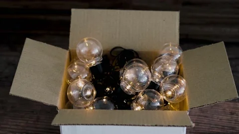 Group of light bulbs shining from an open box, mindset and thinking outside t Stock Footage 148513612