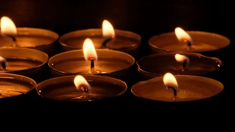 A Group Of Lit Tealight Candles Stock-Footage 94345198