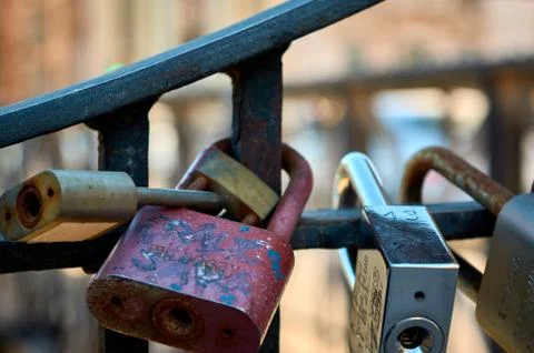 Group of locks tied on a bridge railing Stock Photos