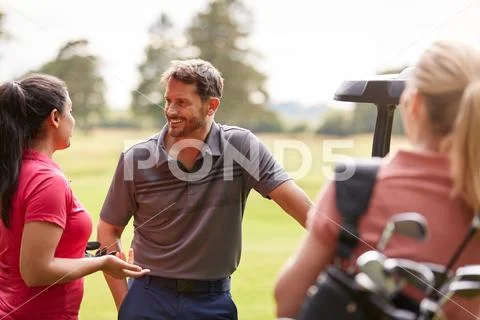 Group Of Male And Female Golfers Standing By Golf Buggy On Course ~ Hi ...