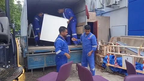 Group of Male Workers Loading Cabinets into Truck Wearing Blue Clothes Stock Footage 307315781