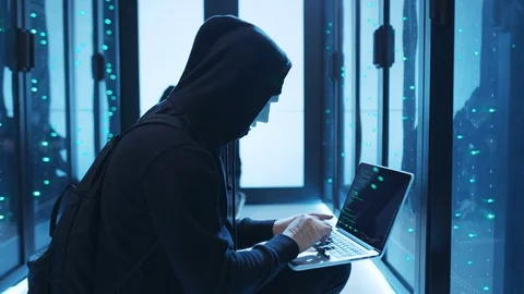 Group of malicious hackers breaking into server room of database, typing spyware Stock Footage 120604762