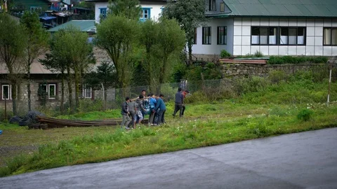 Group of Man Carrying Big Engine Together at Tenzing Hillary Airport Stock Footage 94723577