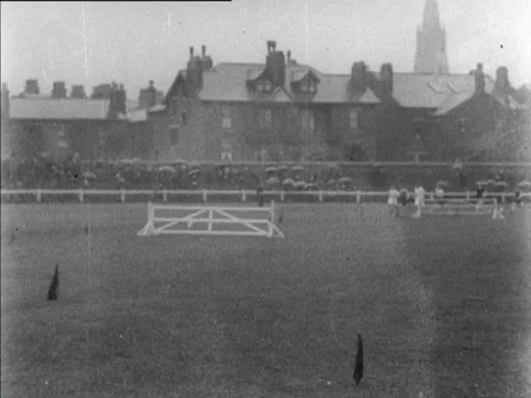 Group of man runners running on stadium with audience cheering, UK, 1902 Stock Footage 136678877