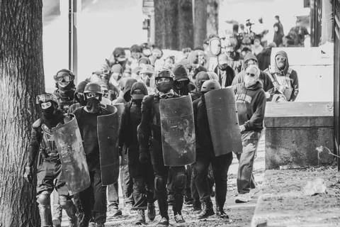 Group marching down the sidewalk Stock Photos