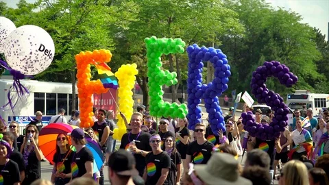 Group marching during Gay Pride with FIERS balloon sign Stock Footage 114346686
