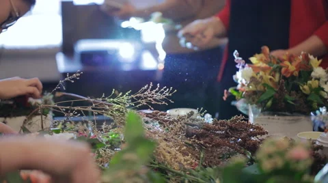 Group master florists, working with flowers, bouquets, boutonnieres, herbs Stock Footage 57771674