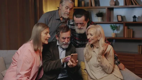 Group of mature people enjoy using smartphone and sitting on sofa in nursing Stock Footage 234420060