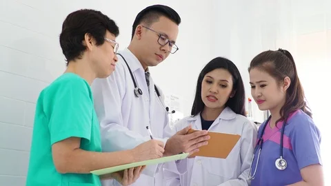 Group of medical team using a tablet computer in meeting Stock Footage 89987492