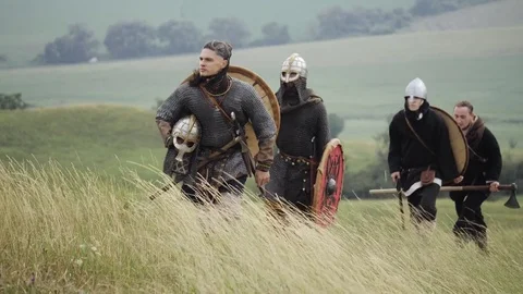 Group of Medieval Viking with shields walking forward on the meadow Stock Footage 81337875