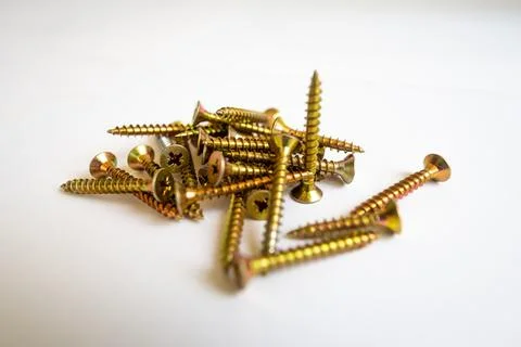 Group of medium sized yellow screws for DIY jobs. Isolated on white background. 写真素材