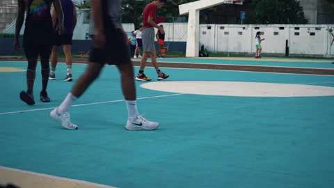 A group of men are actively playing basketball on a basketball court. Stock Footage 170580469