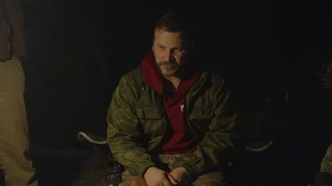 Group of men camping in the wild and gather near the bonfire and talk with each 動画素材 338039036