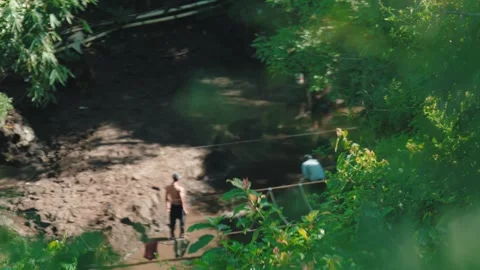 Group of Men Digging and Working in Muddy Riverbed Area Stock Footage 280557244