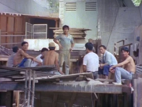 Group of men having a good time while sitting on a wrecked platform Stock Footage 79877950