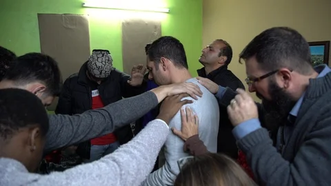 Group of men lay hands and pray for a man 1 스톡 동영상 105017418