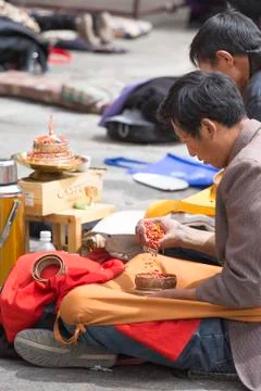 Group of men praying in front of a temple in Lhasa Stock Photos