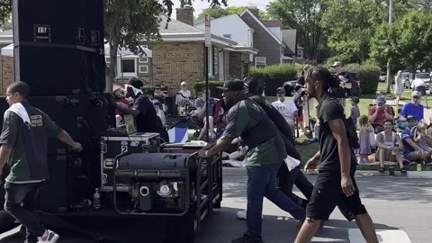 Group of men pushing large speaker stack at a summer festival Stock Footage 245978554