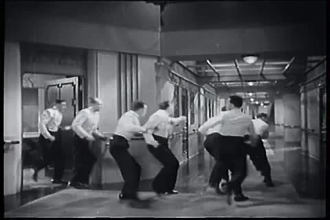 Group of men running down ship corridor Stock Footage 11356053