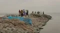 Group of men standing on the rocks near the Indian Ocean in Sri Lanka HD Footage
