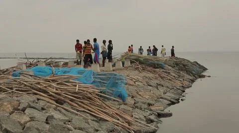 Group of men standing on the rocks near the Indian Ocean in Sri Lanka Stock Footage 49365876