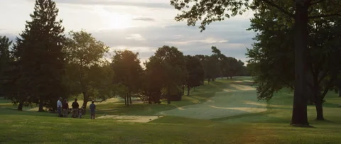 A Group of Men Teeing off at a Golf Course in the Early Morning/Late Afternoon Stock Footage 133742901